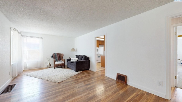 912 S Alder St, Kennewick, WA 99336 - living area with wood finished floors and a textured ceiling