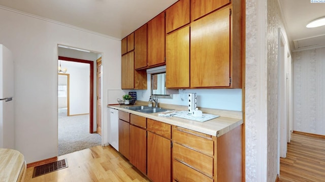 912 S Alder St, Kennewick, WA 99336 - kitchen featuring light wood-style floors, light countertops, wallpapered walls, ornamental molding, and white dishwasher