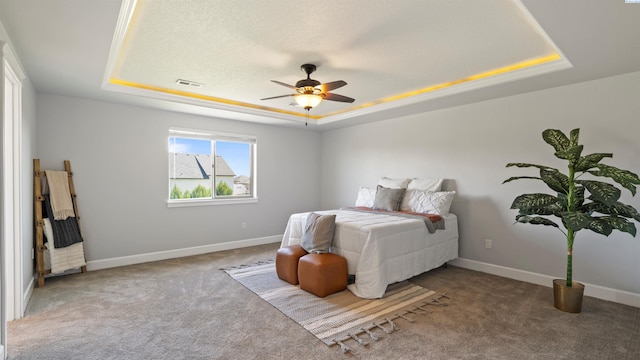 76704 E Timothy Ln, Kennewick, WA 99338 - carpeted bedroom featuring a tray ceiling, baseboards, and a ceiling fan