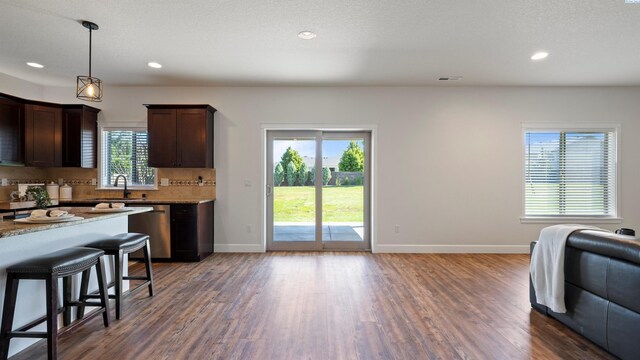 76704 E Timothy Ln, Kennewick, WA 99338 - kitchen with dishwasher, dark wood-style flooring, dark brown cabinetry, open floor plan, and recessed lighting
