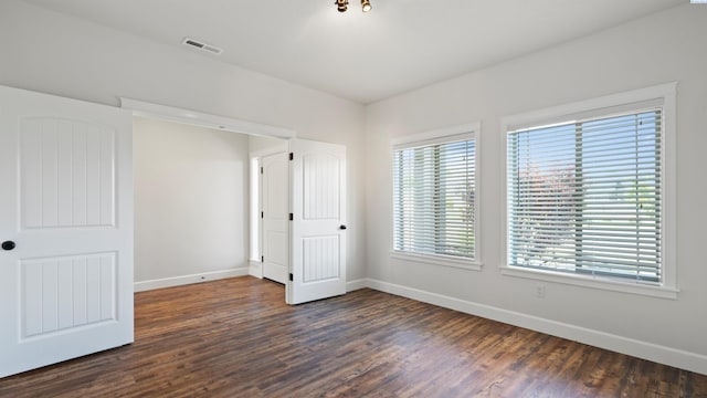 76704 E Timothy Ln, Kennewick, WA 99338 - unfurnished bedroom with baseboards and dark wood-type flooring