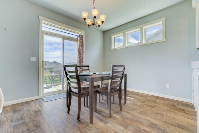 3915 Charleston Ln, Pasco, WA 99301 - dining space featuring a chandelier and light wood-style flooring