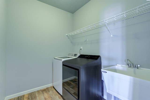 3915 Charleston Ln, Pasco, WA 99301 - laundry area with independent washer and dryer and light wood-type flooring