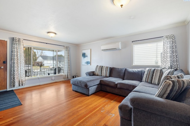 living room featuring hardwood / wood-style flooring, ornamental molding, and a wall mounted air conditioner