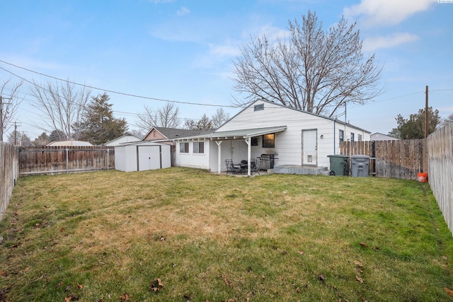 back of property featuring a storage shed and a lawn