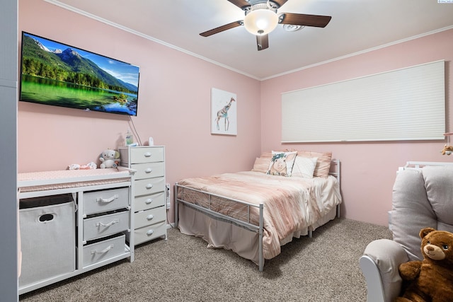 carpeted bedroom featuring crown molding and ceiling fan