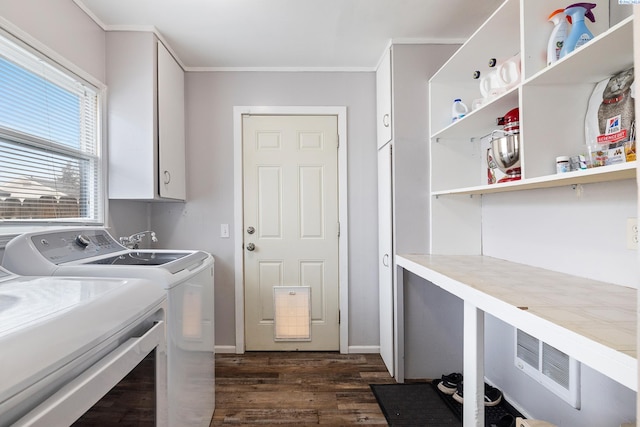 clothes washing area featuring cabinets, ornamental molding, dark hardwood / wood-style flooring, and washing machine and dryer