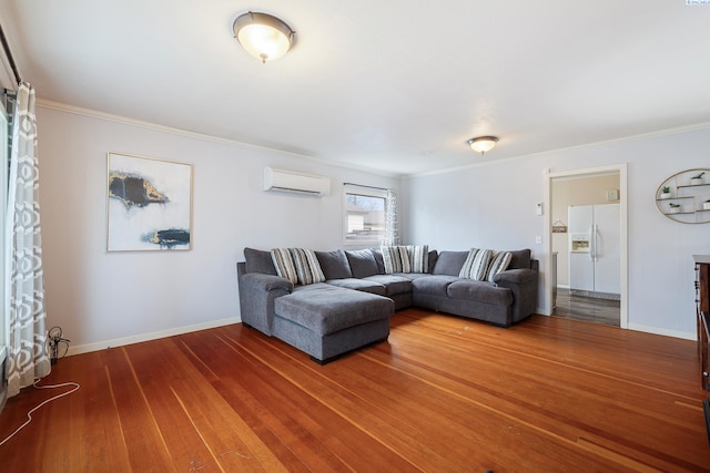 living room with wood-type flooring, ornamental molding, and a wall mounted AC