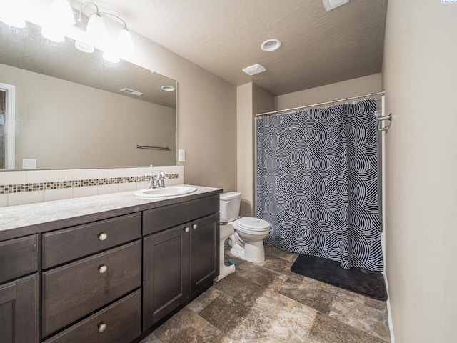 4268 Hedman Ct, Moses Lake, WA 98837 - full bath featuring vanity, stone finish floors, decorative backsplash, and a shower with curtain