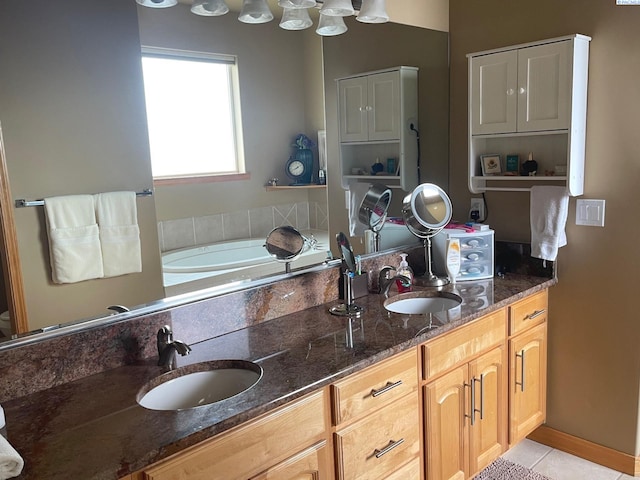 full bath featuring double vanity, tile patterned flooring, and a sink