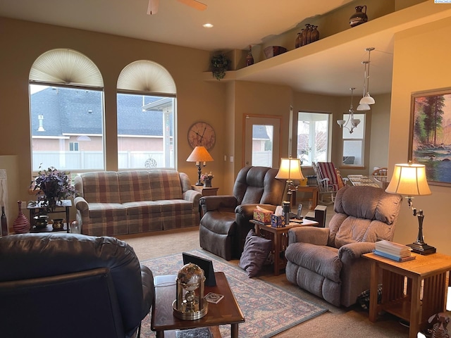 living room featuring carpet and a ceiling fan