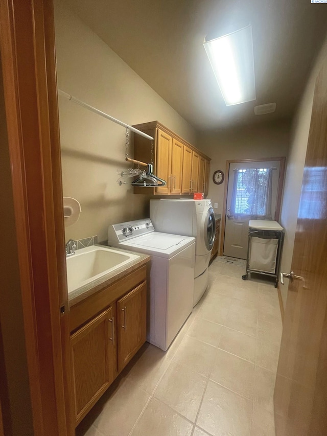 laundry room with separate washer and dryer, light tile patterned flooring, a sink, and cabinet space