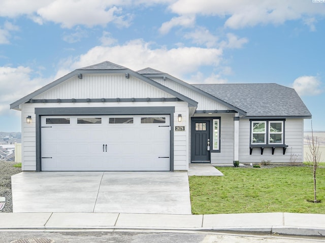 view of front of home featuring a garage and a front yard