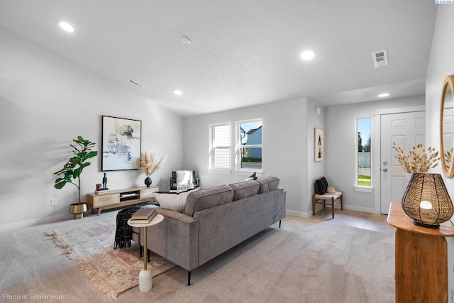 living room with light colored carpet and vaulted ceiling