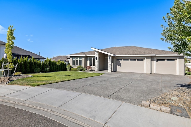 540 Athens Dr, West Richland, WA 99353 - view of front of property with a garage, concrete driveway, a front yard, and stucco siding