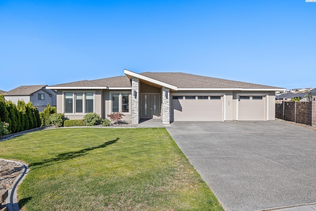 540 Athens Dr, West Richland, WA 99353 - view of front of property featuring an attached garage, concrete driveway, stone siding, and stucco siding