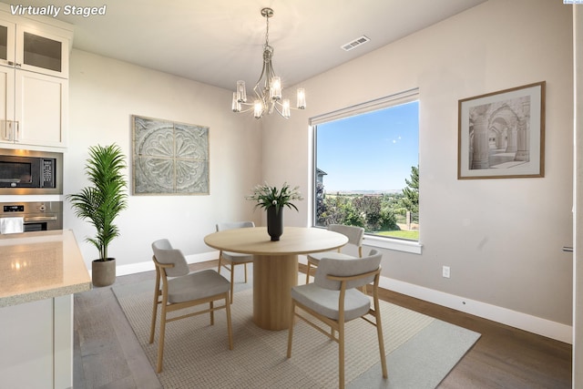 540 Athens Dr, West Richland, WA 99353 - dining room featuring wood finished floors and a chandelier