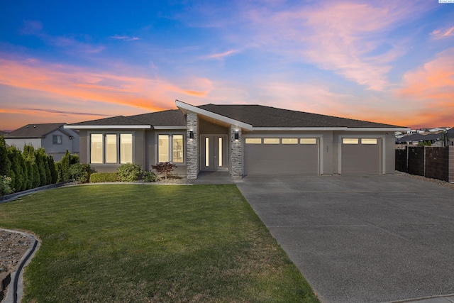 540 Athens Dr, West Richland, WA 99353 - view of front facade with an attached garage, driveway, stucco siding, and stone siding