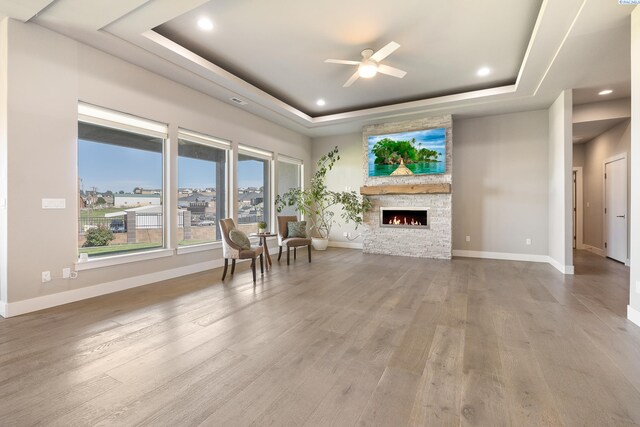 540 Athens Dr, West Richland, WA 99353 - living room featuring a raised ceiling, ceiling fan, healthy amount of natural light, a stone fireplace, and recessed lighting