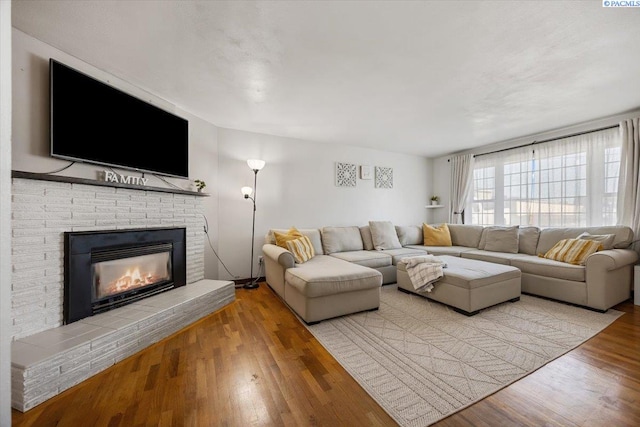 living room with a fireplace and light hardwood / wood-style floors