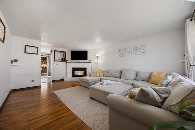 living room with hardwood / wood-style flooring and a fireplace