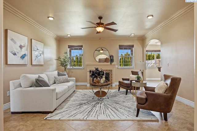 4617 W Dradie St, Pasco, WA 99301 - living area featuring ceiling fan, ornamental molding, baseboards, arched walkways, and a fireplace