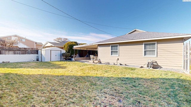 rear view of house with a storage shed, a yard, and an outbuilding