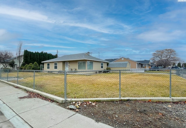 view of front of property featuring a residential view, fence, and a front lawn