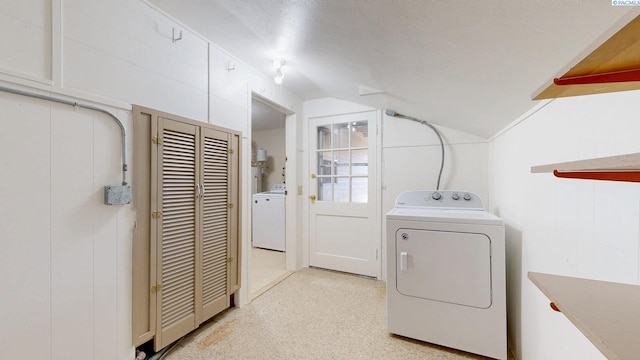 washroom with washer / dryer, laundry area, and a textured ceiling