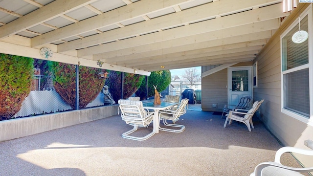 view of patio featuring a grill, fence, and outdoor dining space