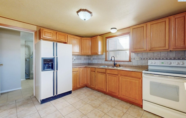 kitchen with light tile patterned flooring, white appliances, a sink, light countertops, and decorative backsplash