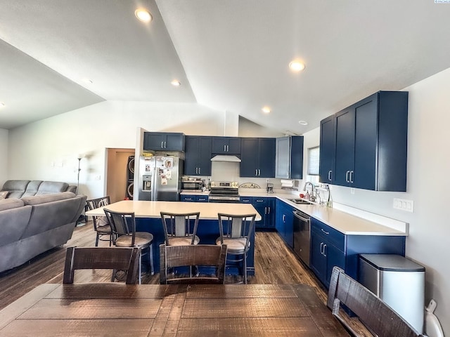 kitchen featuring blue cabinets, a breakfast bar, sink, appliances with stainless steel finishes, and a kitchen island