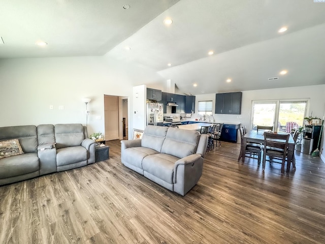 living room featuring lofted ceiling and hardwood / wood-style floors