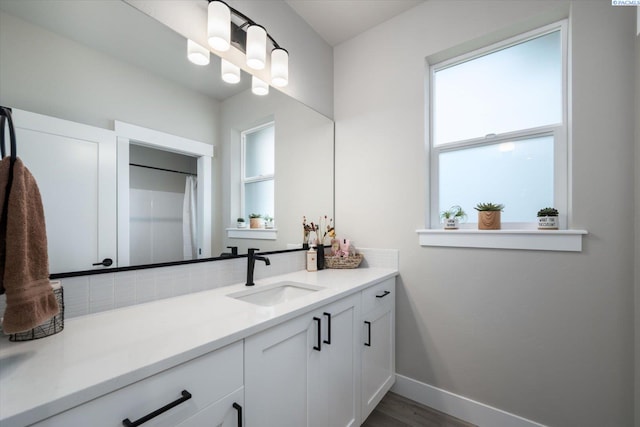 bathroom featuring vanity, wood-type flooring, and backsplash