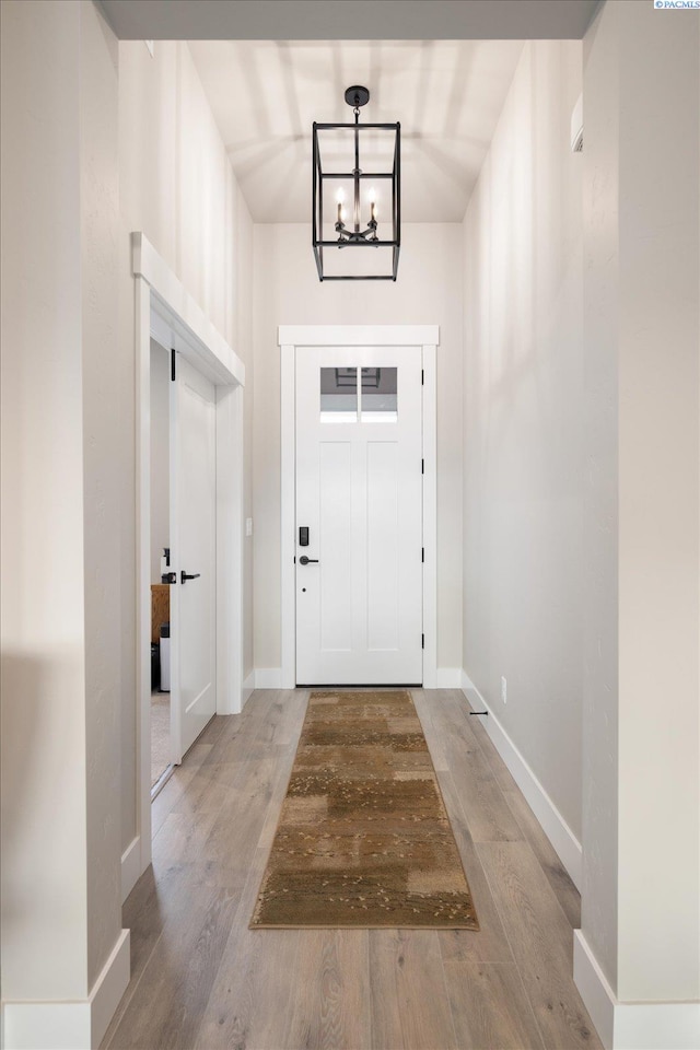 doorway featuring hardwood / wood-style flooring and an inviting chandelier