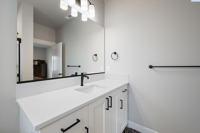 bathroom with vanity and decorative backsplash