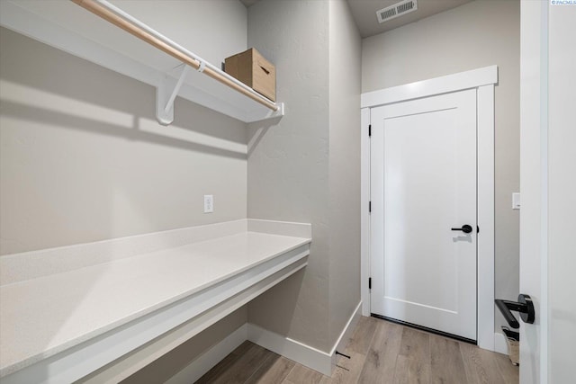 laundry room featuring light hardwood / wood-style flooring