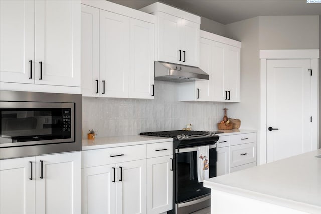 kitchen featuring white cabinetry, stainless steel appliances, and backsplash