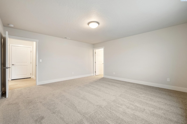 carpeted spare room with a textured ceiling