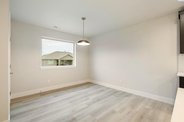 unfurnished dining area with light hardwood / wood-style floors