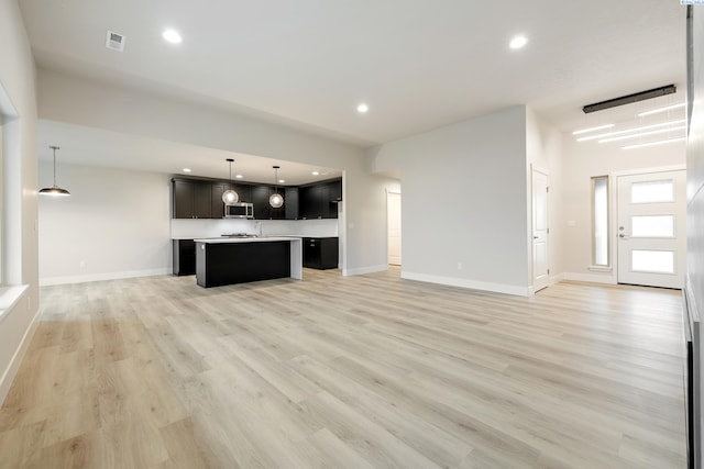 unfurnished living room featuring light wood-type flooring