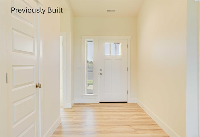 entrance foyer featuring visible vents, baseboards, and light wood finished floors