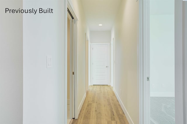 hallway featuring recessed lighting, light wood-style floors, and baseboards