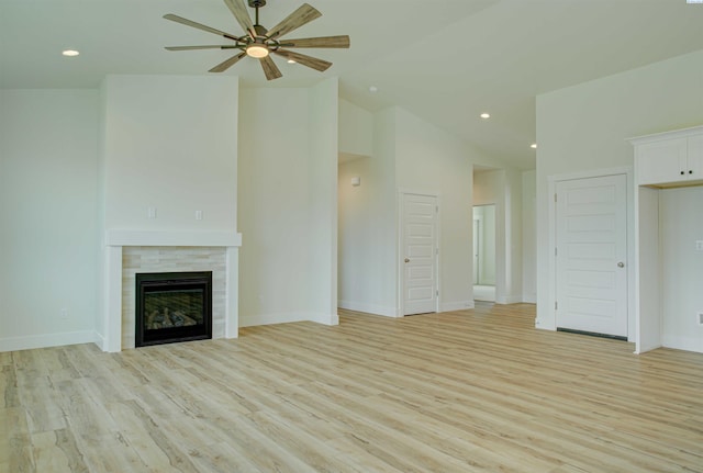 4003 Rd 96, Pasco, WA 99301 - unfurnished living room with a ceiling fan, light wood-style flooring, a tile fireplace, lofted ceiling, and recessed lighting