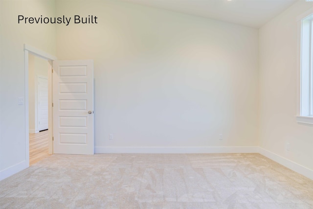 carpeted empty room with a healthy amount of sunlight and baseboards