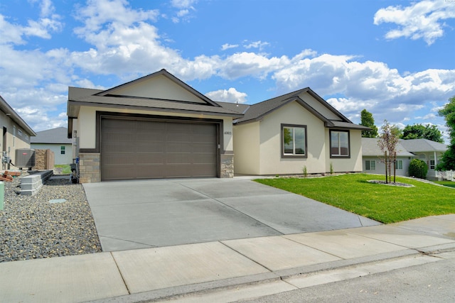 4003 Rd 96, Pasco, WA 99301 - single story home with stucco siding, driveway, a front yard, an attached garage, and stone siding