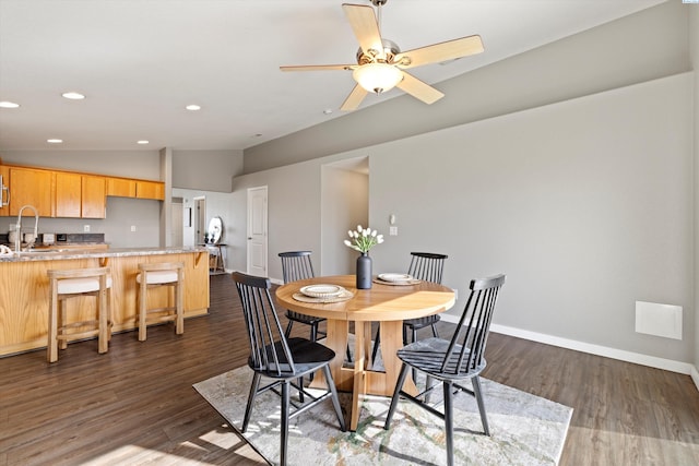 dining area with lofted ceiling, dark wood finished floors, baseboards, and recessed lighting