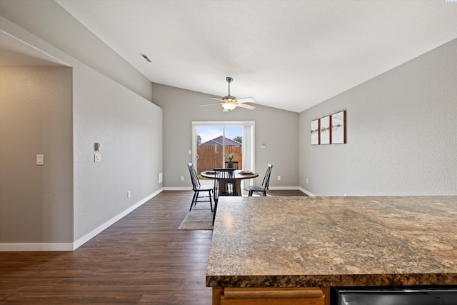 kitchen with visible vents, baseboards, dark wood finished floors, a ceiling fan, and lofted ceiling