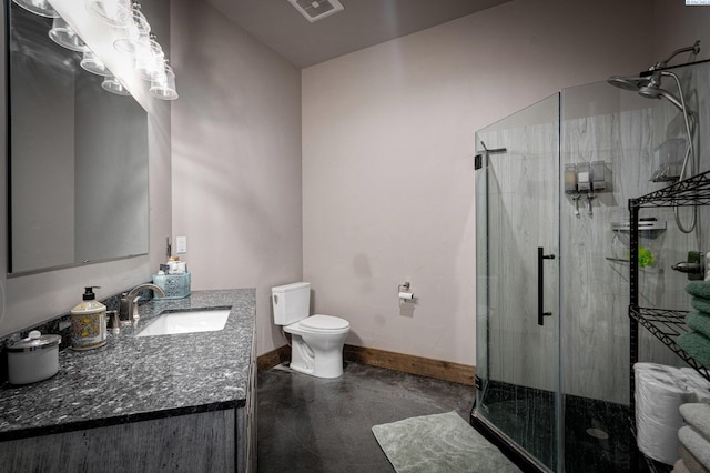 bathroom featuring vanity, an enclosed shower, and toilet