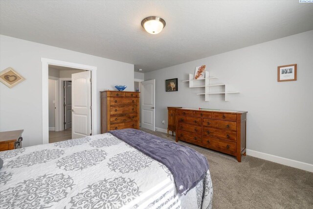 bedroom with carpet floors and baseboards